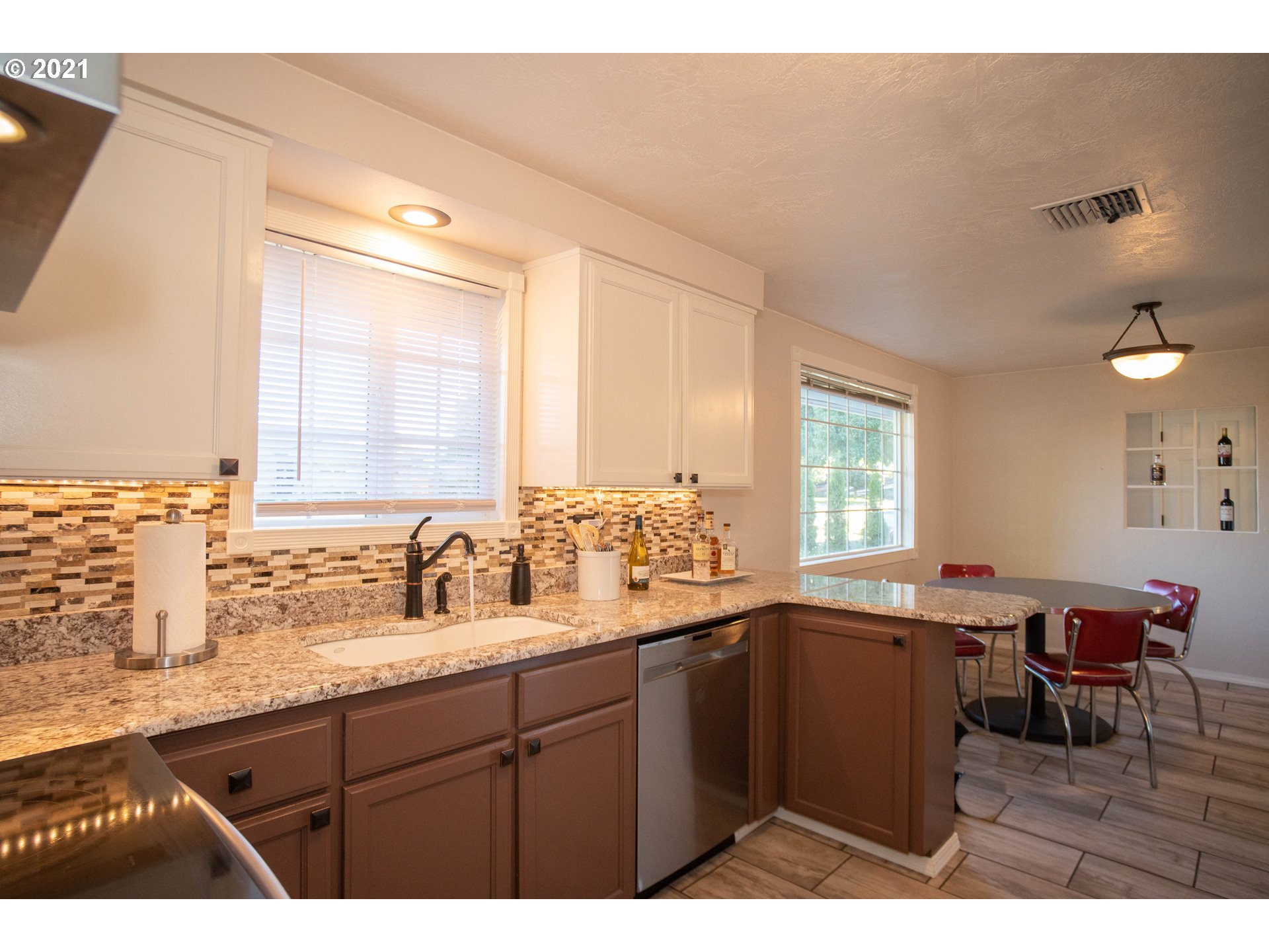 3950 Jasper Road Springfield, OR 97478 - Photo 4 of 20 a kitchen with a sink a window and chairs