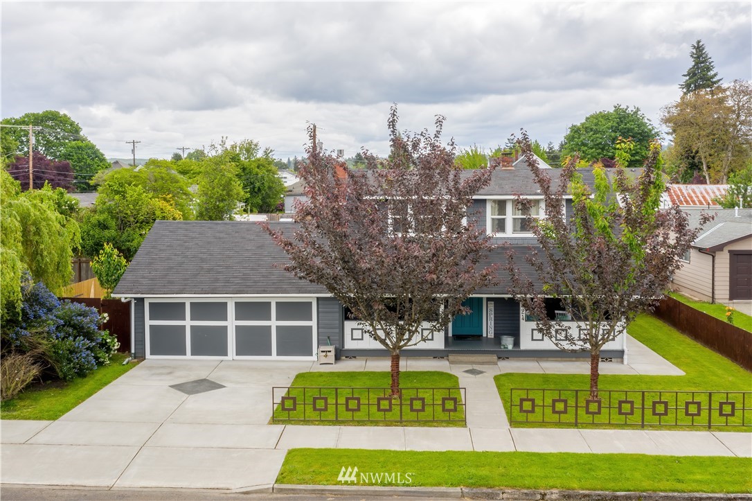 a view of house with swimming pool and outdoor seating