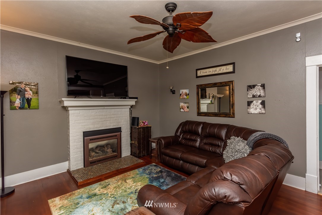 324 N Street Centralia, WA 98531 - Photo 3 of 32 a living room with furniture a flat screen tv and a fireplace
