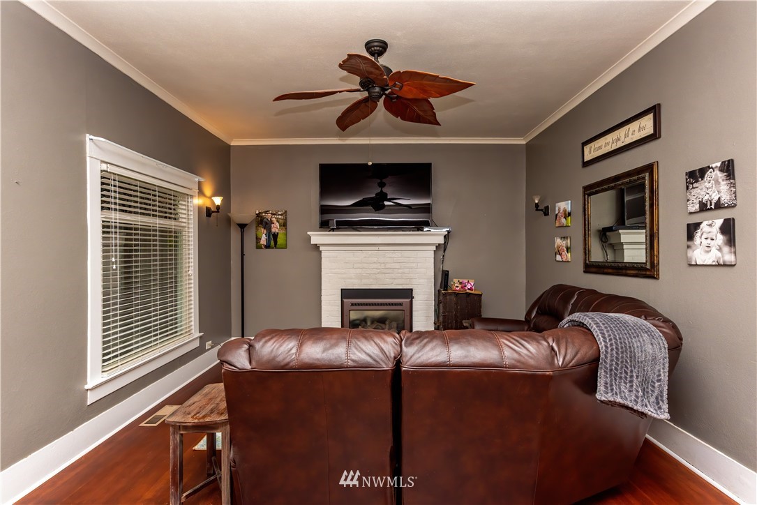 324 N Street Centralia, WA 98531 - Photo 5 of 32 a living room with furniture a flat screen tv and a fireplace