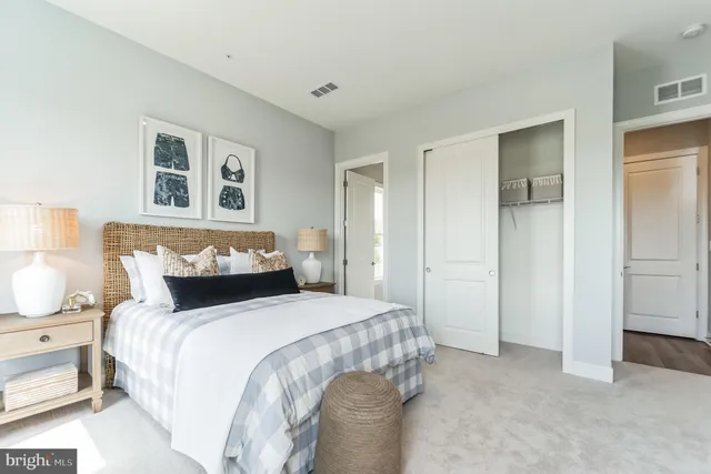 a bedroom with a bed and a painting