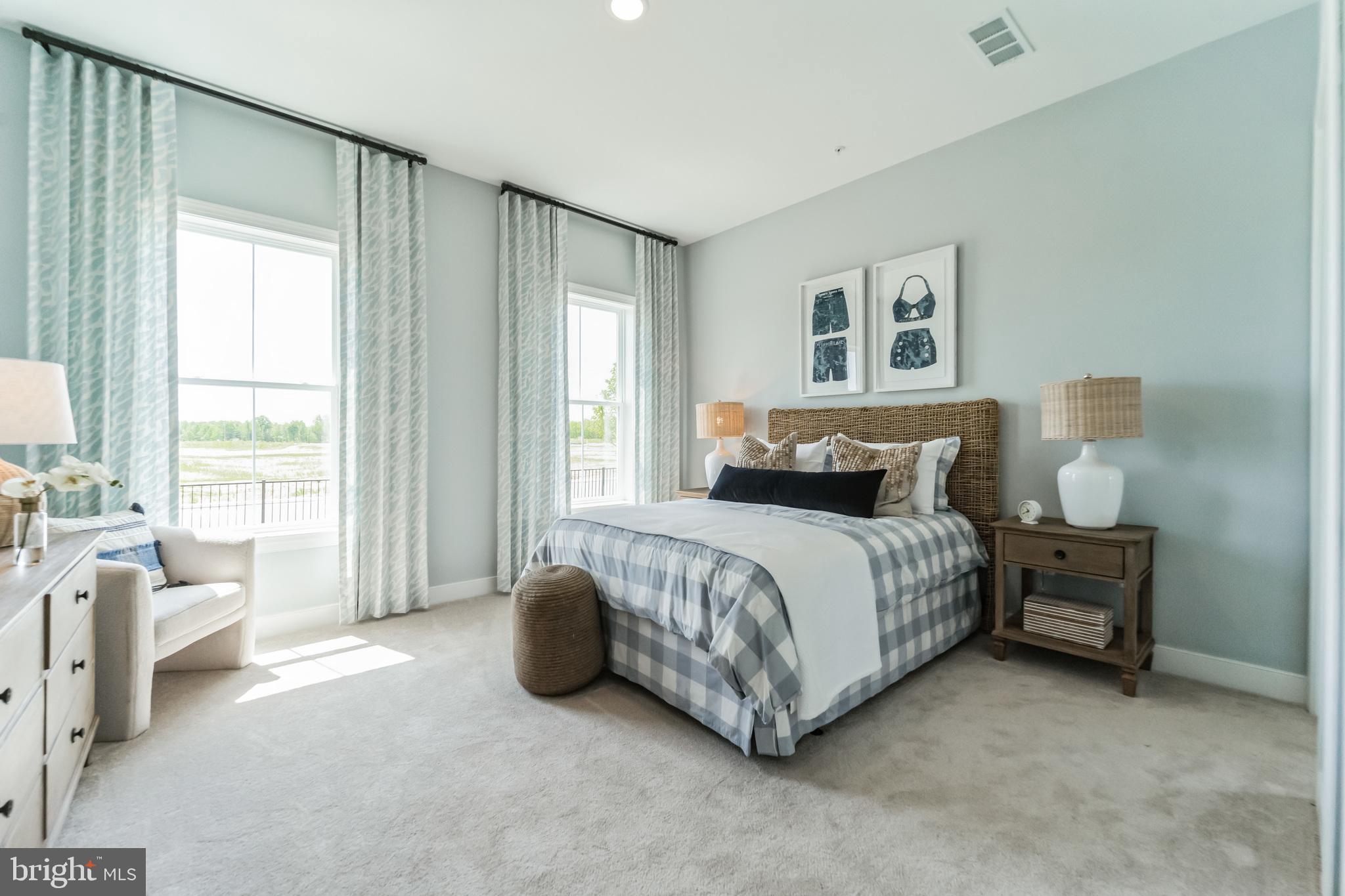 117 Flycatcher Way Stevensville, MD 21666 - Photo 17 of 49 a spacious bedroom with a bed and a couch