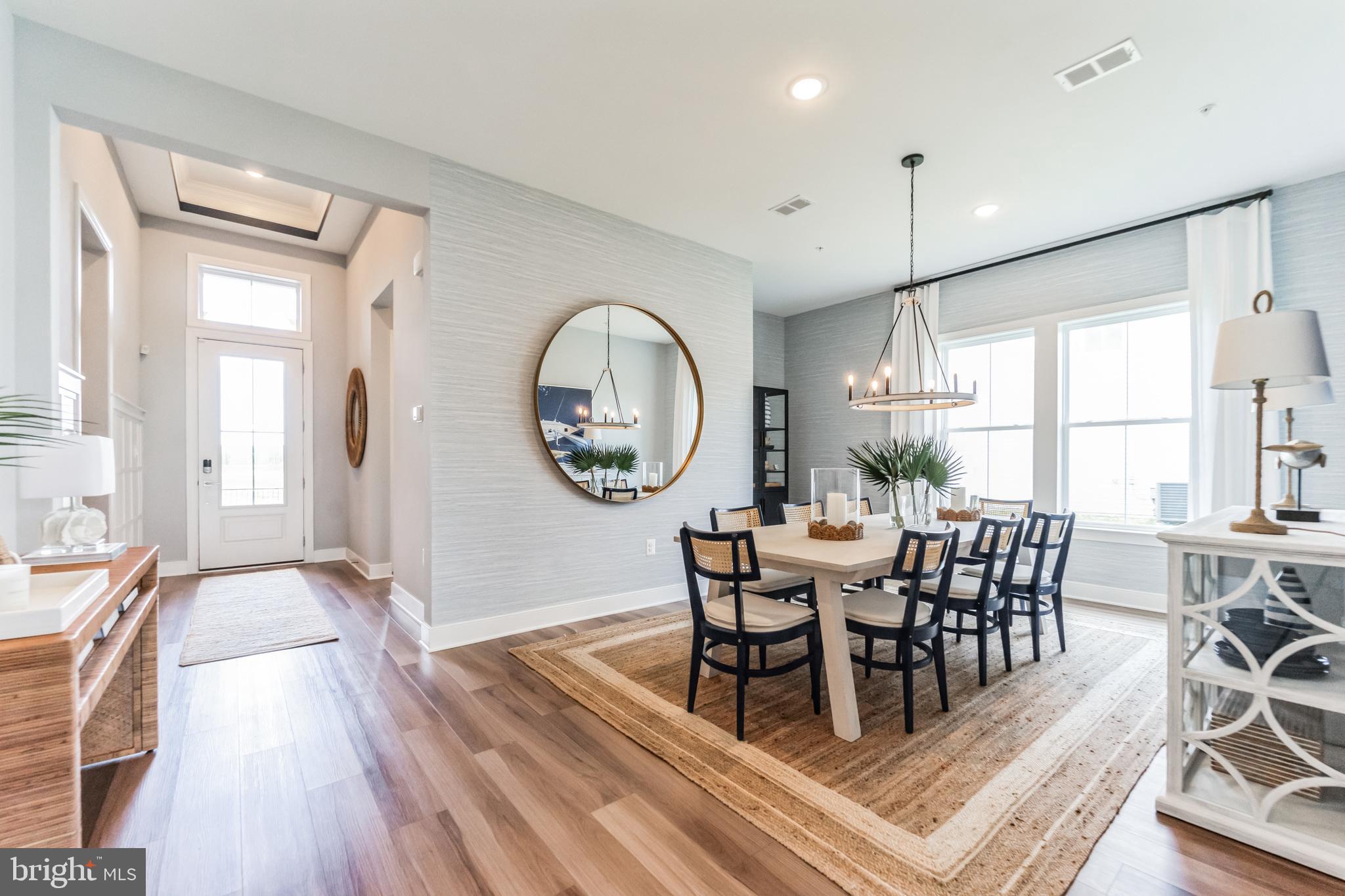 117 Flycatcher Way Stevensville, MD 21666 - Photo 2 of 49 a dining room with wooden floor a glass table and chairs