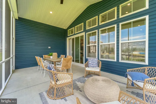 a view of a patio with a dining table and chairs with wooden floor