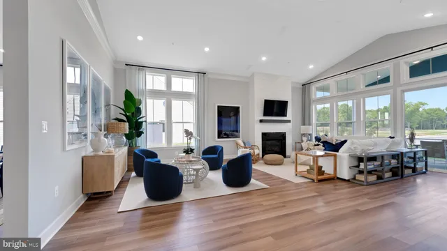 a living room with fireplace furniture and a large window