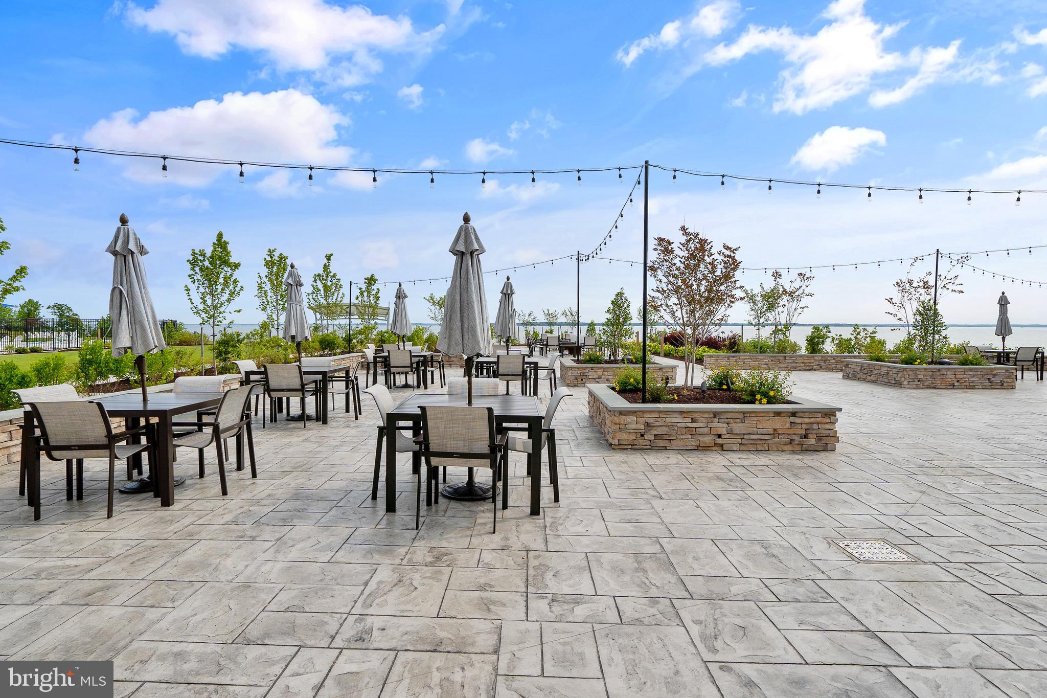 117 Flycatcher Way Stevensville, MD 21666 - Photo 43 of 49 a view of a patio with dining table and chairs with a stove
