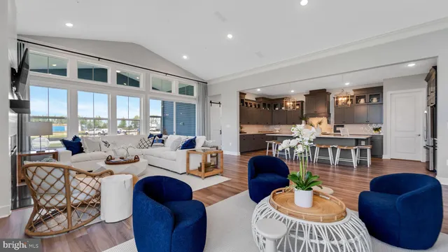 a living room with furniture fireplace and a large window