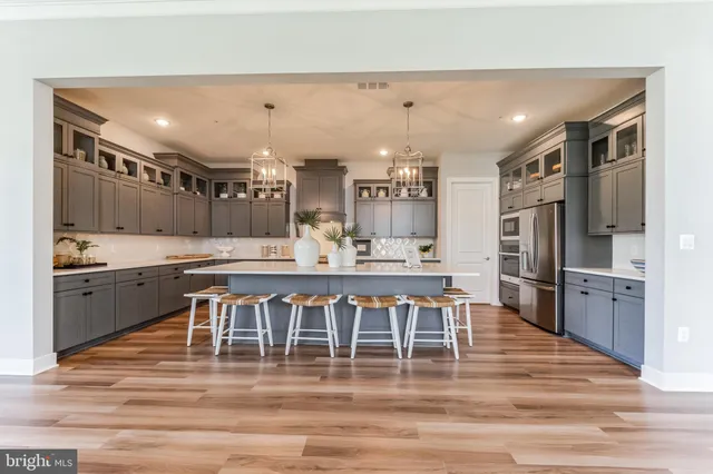 a large kitchen with a table and chairs