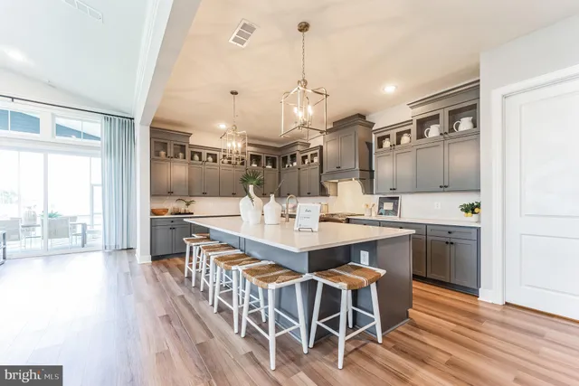 a large kitchen with a table and chairs