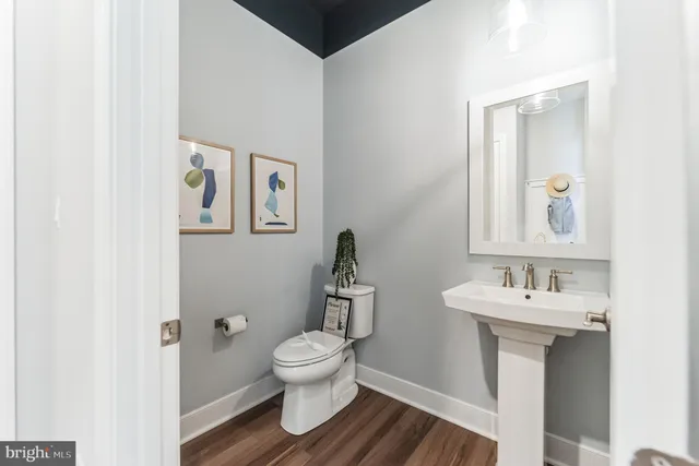 a bathroom with a toilet sink and mirror