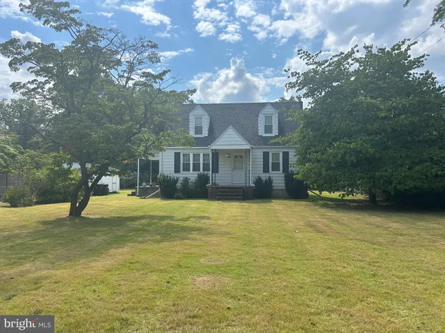 a view of front door and a yard