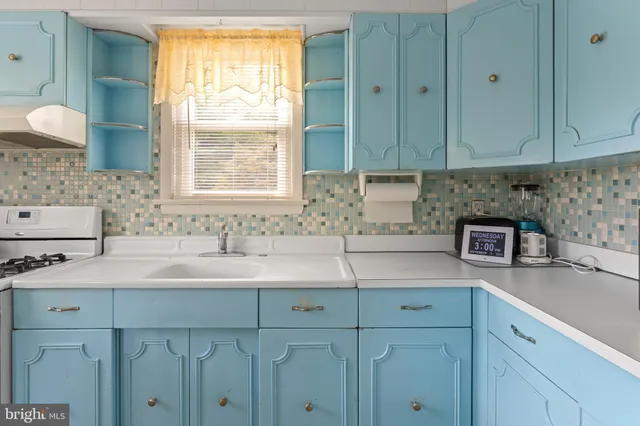 a kitchen with a sink cabinets and window