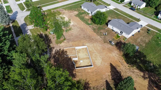 an aerial view of a house with a yard