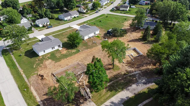an aerial view of a house with a yard