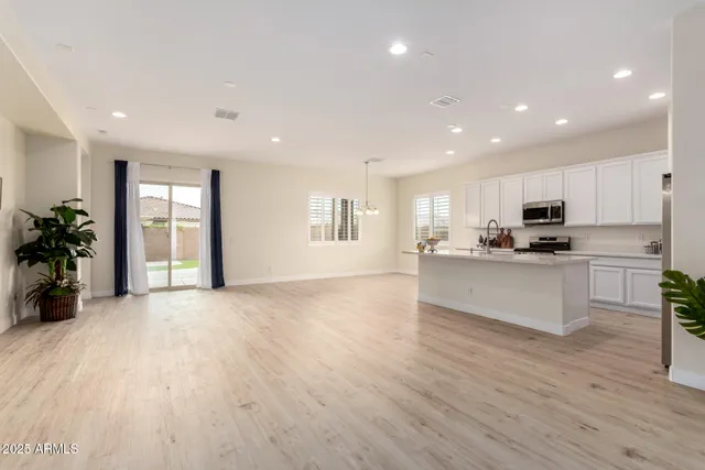 a large kitchen with stainless steel appliances granite countertop a large window a oven and a sink