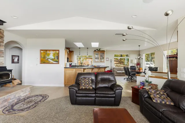 a living room with furniture kitchen and a chandelier