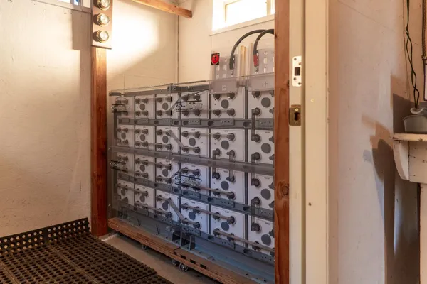 a view of a patio with table and chairs and potted plants with large tree