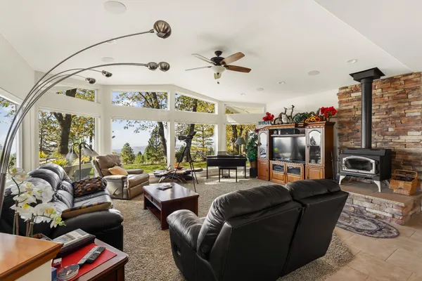 a living room with furniture fireplace and a large window