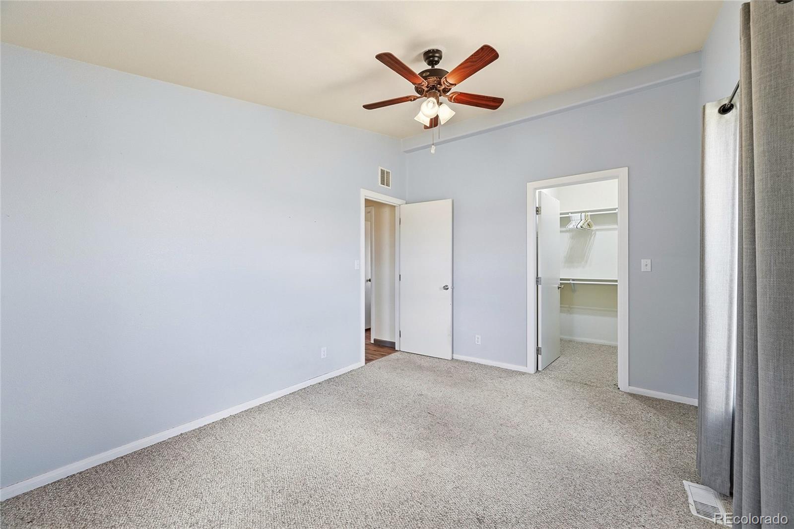 20300 Old Ranch Loop Nathrop, CO 81236 - Photo 21 of 35 an empty room with a ceiling fan and a window