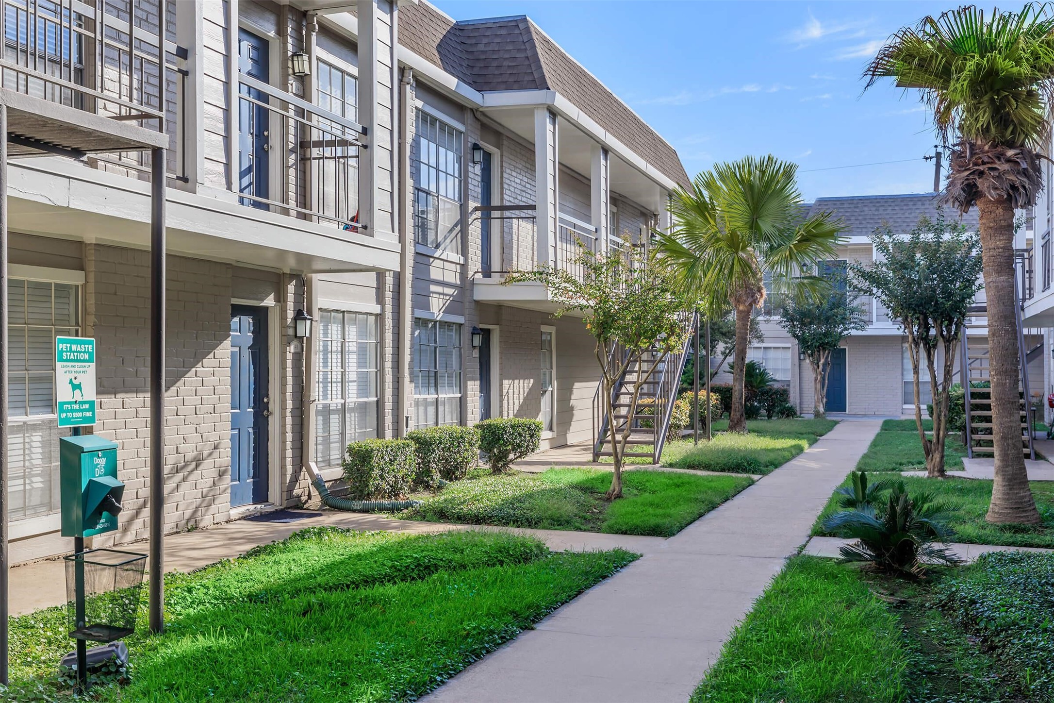 6041 Winsome Lane, Unit 106 Houston, TX 77057 - Photo 18 of 18 a view of a building with a yard and plants