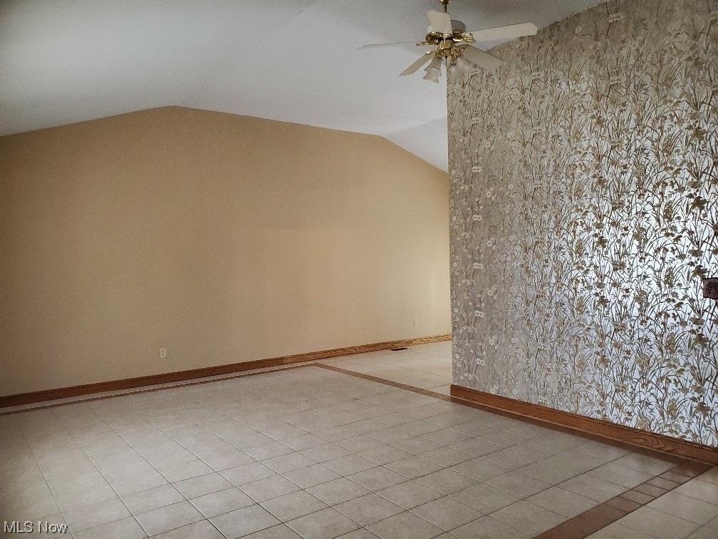 12221 Reno Drive Parma, OH 44130 - Photo 10 of 29 Tiled empty room featuring vaulted ceiling