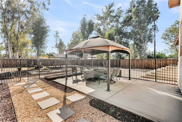 a view of backyard with outdoor seating and trees