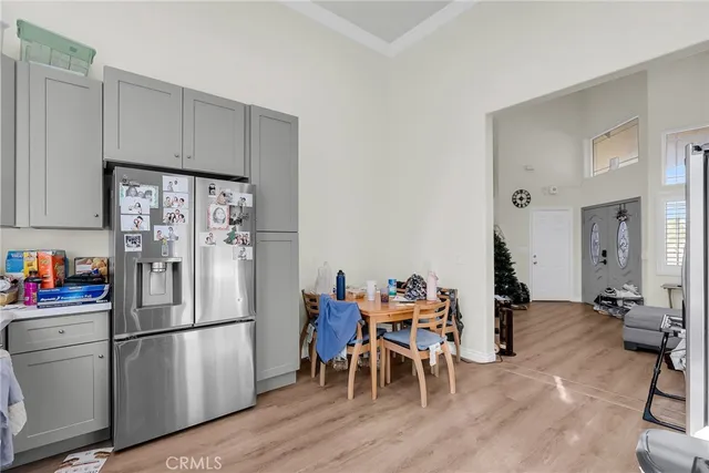 a kitchen with stainless steel appliances a refrigerator and wooden floors