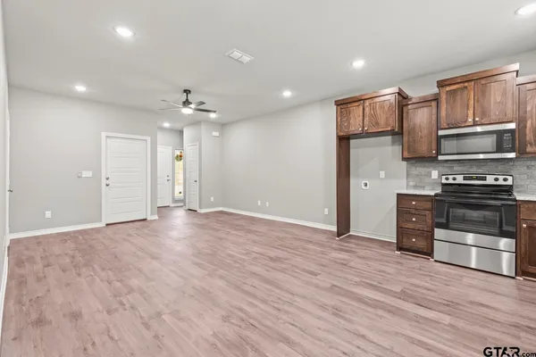 a view of kitchen with sink and microwave