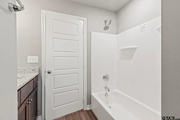 a bathroom with a bathtub and a shower