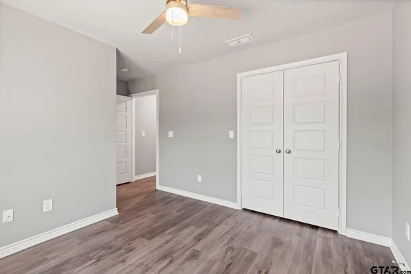 a view of an empty room with wooden floor