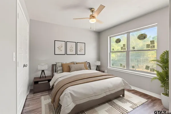 a bedroom with a large bed and a window