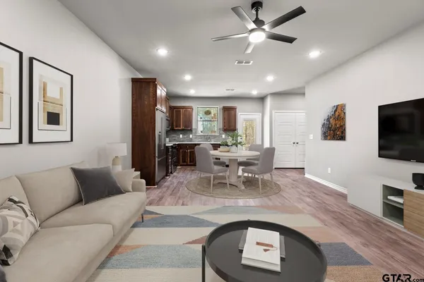 a living room with furniture and a flat screen tv