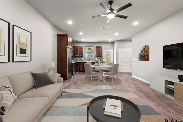 a living room with furniture and a flat screen tv