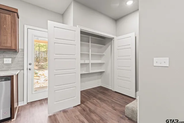 a view of walk in closet with empty racks