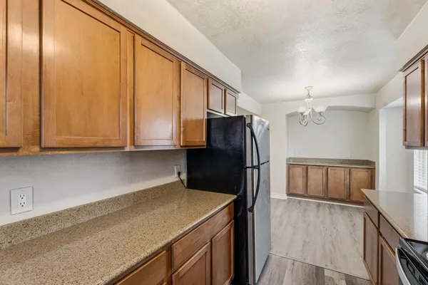 a kitchen with a refrigerator a stove and cabinets