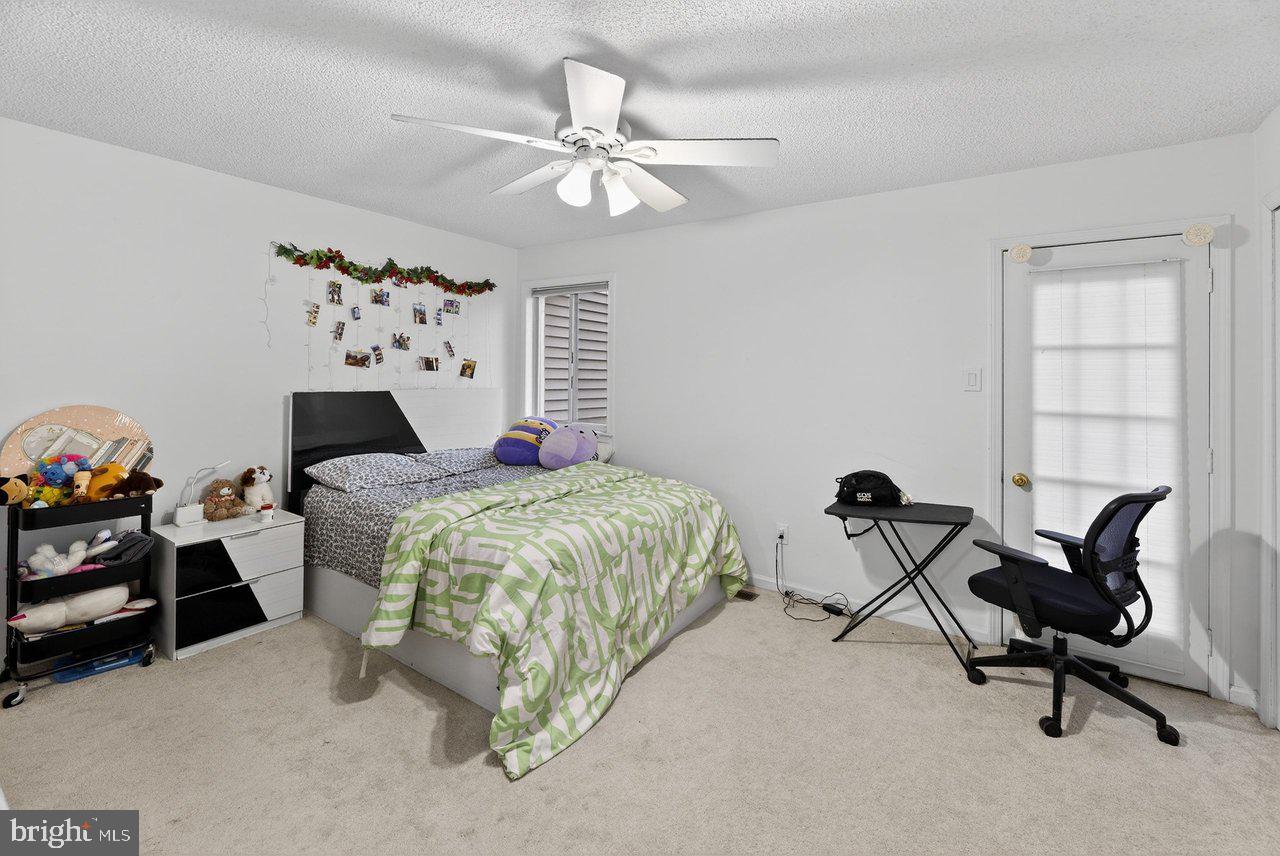 423 Cannon Court, Unit 423 Chesterbrook, PA 19087 - Photo 11 of 26 a bedroom with a bed a chair and the dresser next to it