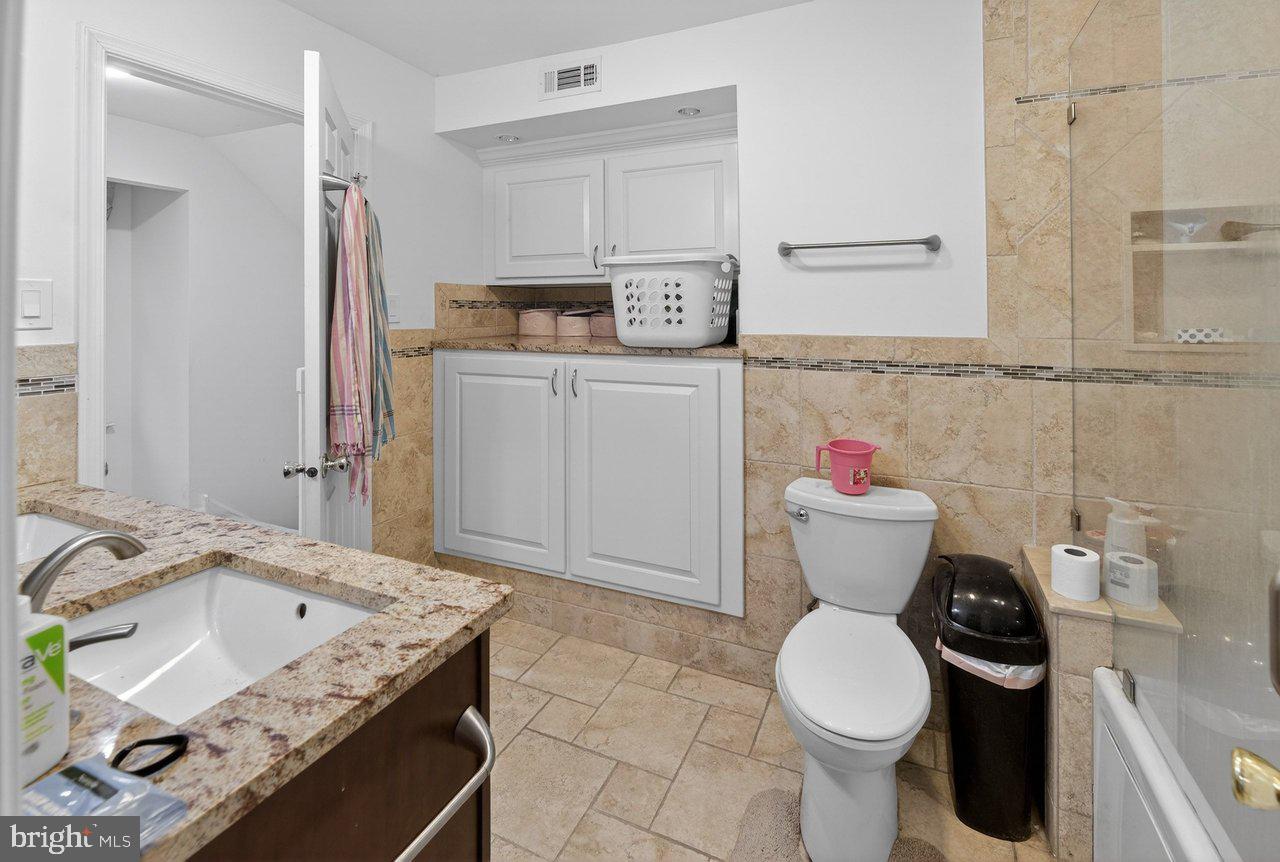 423 Cannon Court, Unit 423 Chesterbrook, PA 19087 - Photo 14 of 26 a bathroom with a granite countertop toilet sink and mirror