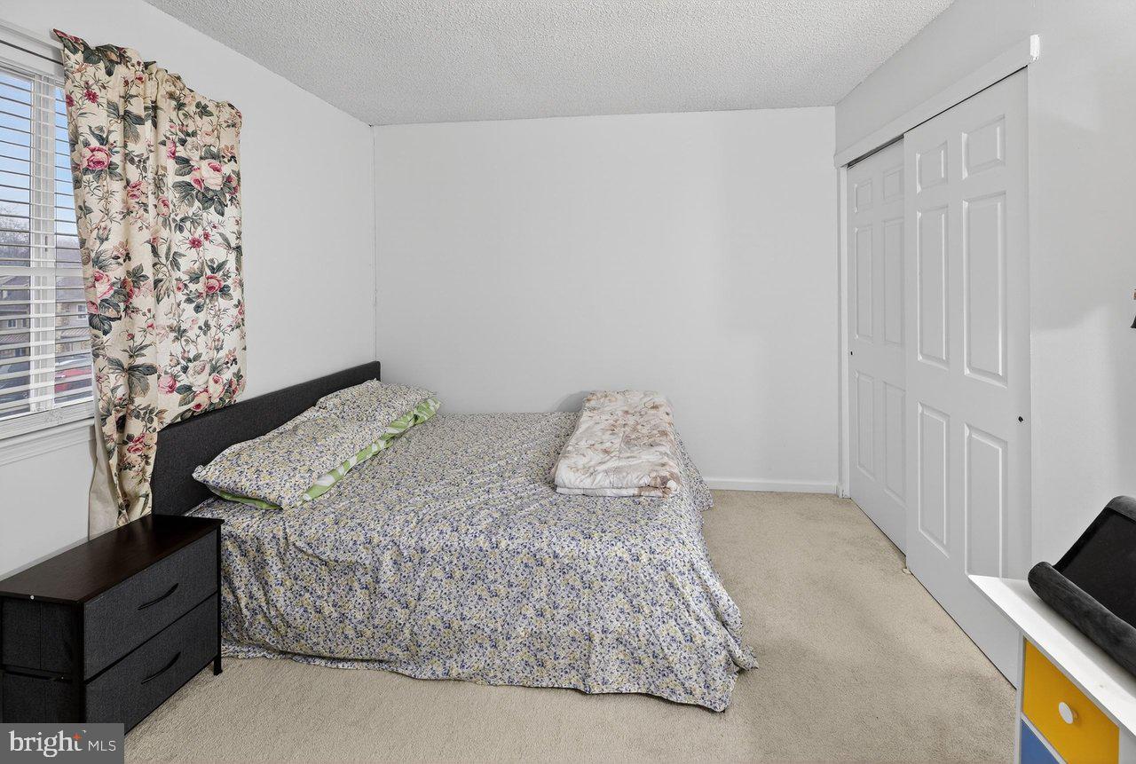 423 Cannon Court, Unit 423 Chesterbrook, PA 19087 - Photo 15 of 26 a bed sitting in a bedroom next to a cabinet