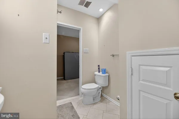 a bathroom with a toilet and a mirror