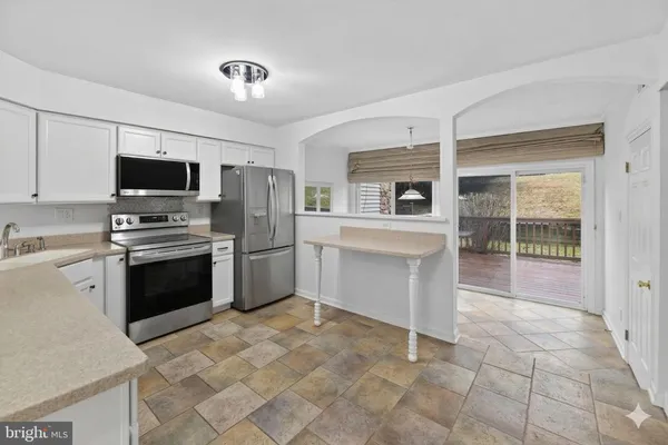 a kitchen with a stove a sink and a refrigerator