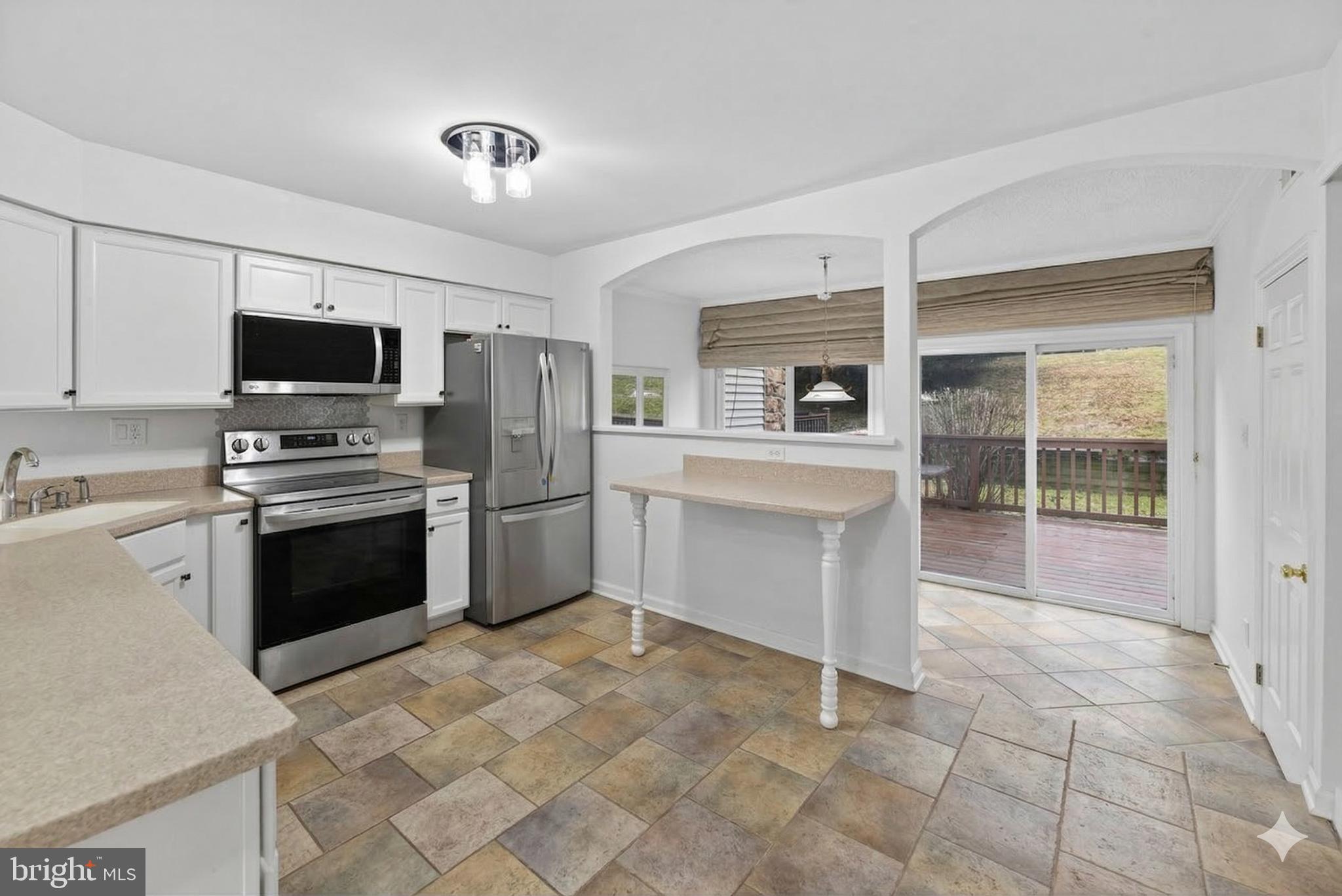 423 Cannon Court, Unit 423 Chesterbrook, PA 19087 - Photo 5 of 26 a kitchen with a stove a sink and a refrigerator