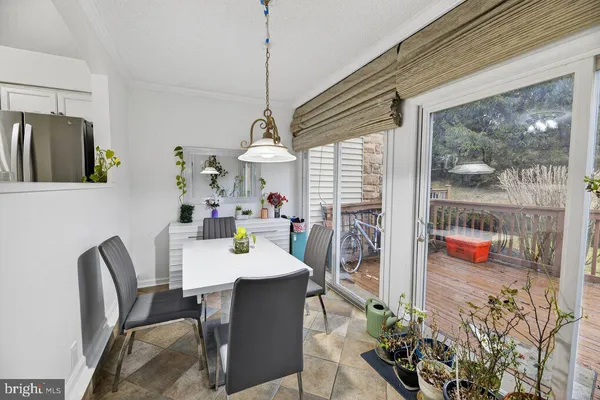 a view of a dining room with furniture a livingroom and chandelier
