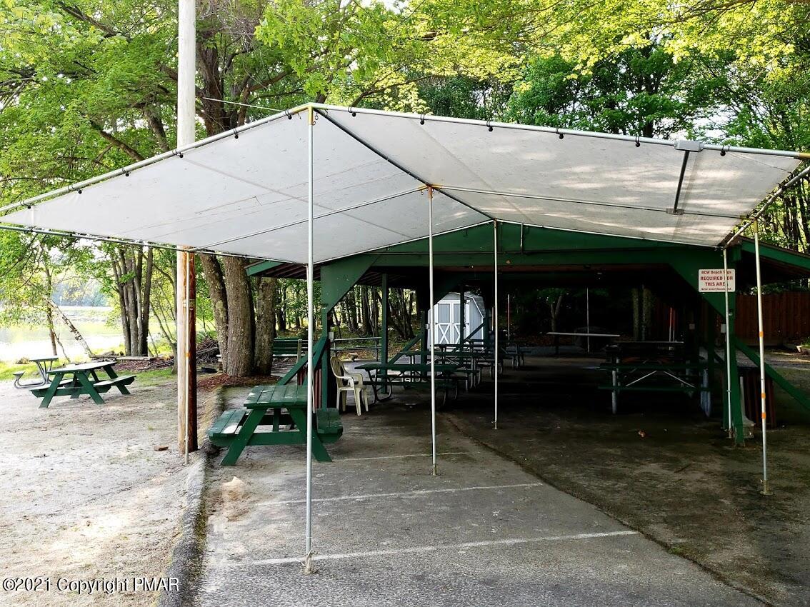 1 Brier Crest Road Blakeslee, PA 18610 - Photo 6 of 22 a patio with a table and chairs under an umbrella