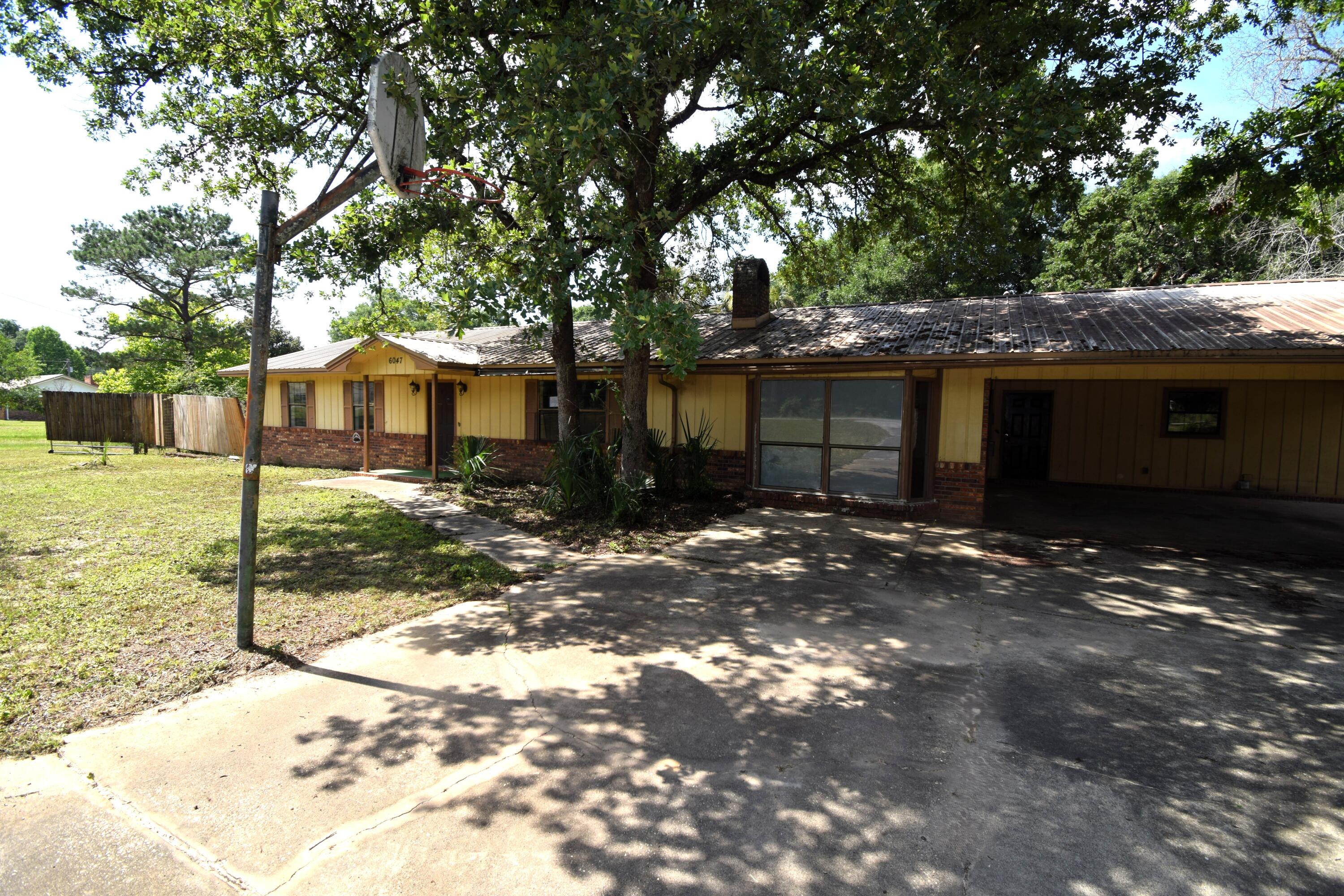6047 Eden Square Crestview, FL 32539 - Photo 37 of 39 a front view of a house with a yard