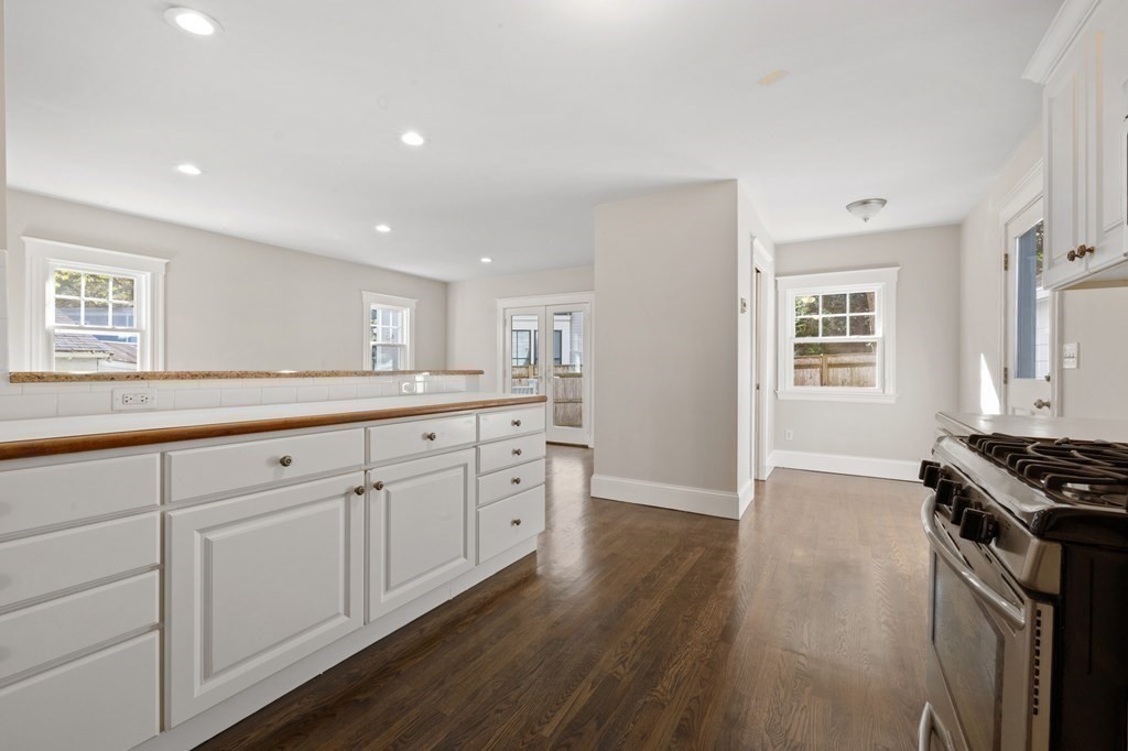 3 Dexter Road Wellesley, MA 02482 - Photo 11 of 40 a kitchen with white cabinets and a stove top oven