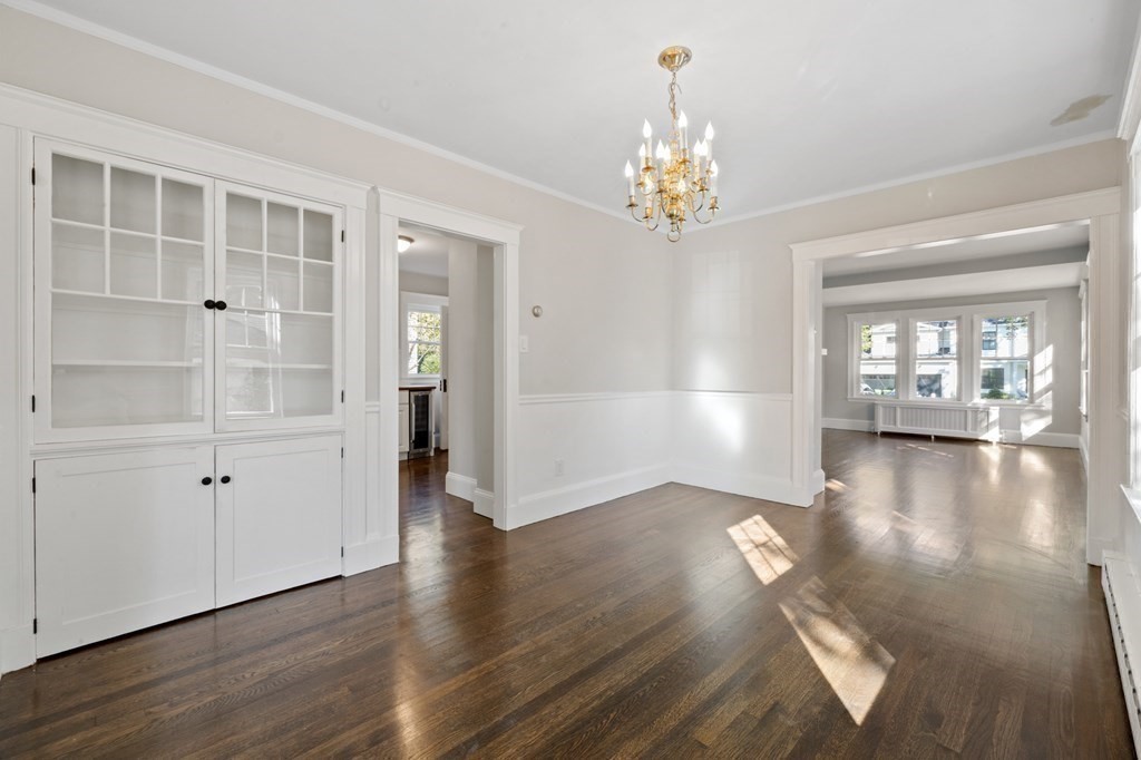 3 Dexter Road Wellesley, MA 02482 - Photo 15 of 40 an empty room with wooden floor chandelier and windows