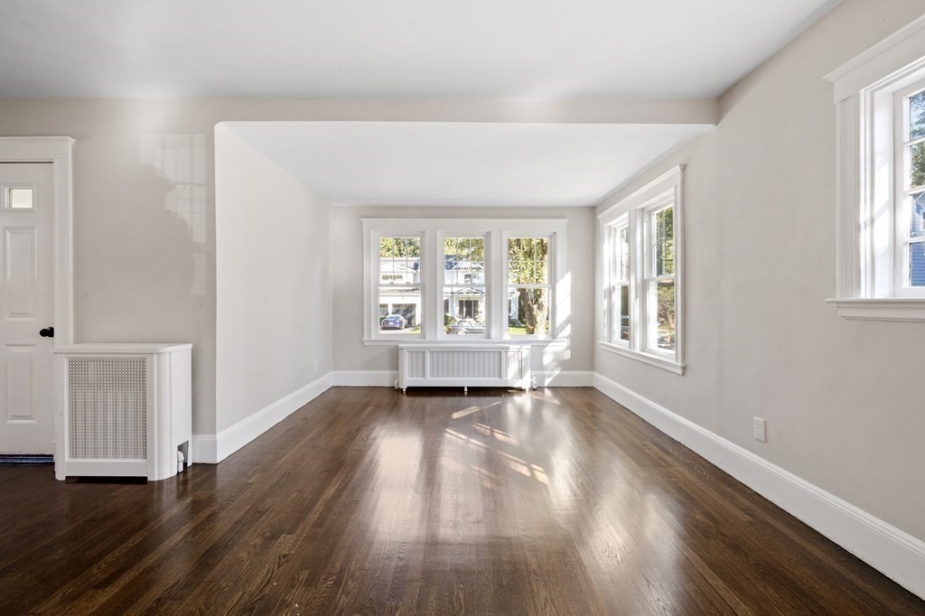 3 Dexter Road Wellesley, MA 02482 - Photo 19 of 40 an empty room with wooden floor and windows