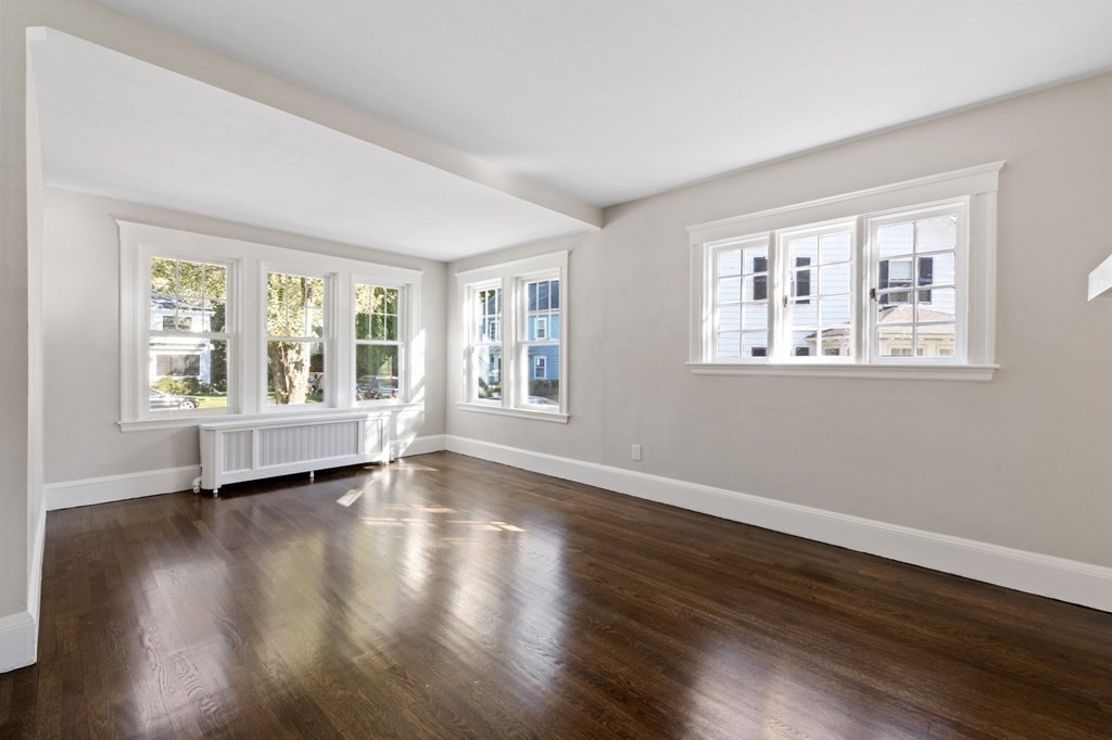 3 Dexter Road Wellesley, MA 02482 - Photo 21 of 40 a view of an empty room with wooden floor and a window