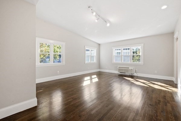 3 Dexter Road Wellesley, MA 02482 - Photo 24 of 40 a view of an empty room with wooden floor and a window