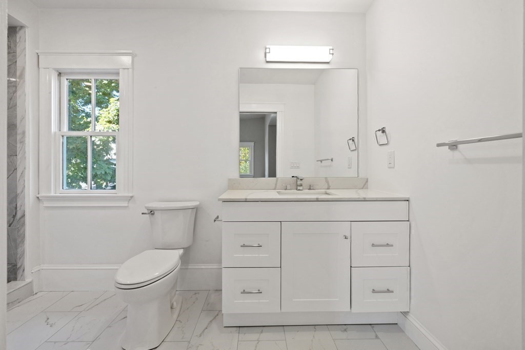 3 Dexter Road Wellesley, MA 02482 - Photo 26 of 40 a bathroom with a toilet a sink a vanity a window and mirror